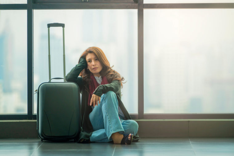 A woman is frustrated because she is experiencing delays.